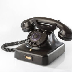 Black bakelite classic rotary phone isolated on white